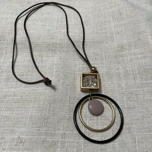 Long necklace with decorative metal and stones